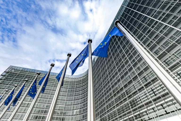 european union blue and gold flags flying in brussels, belgium